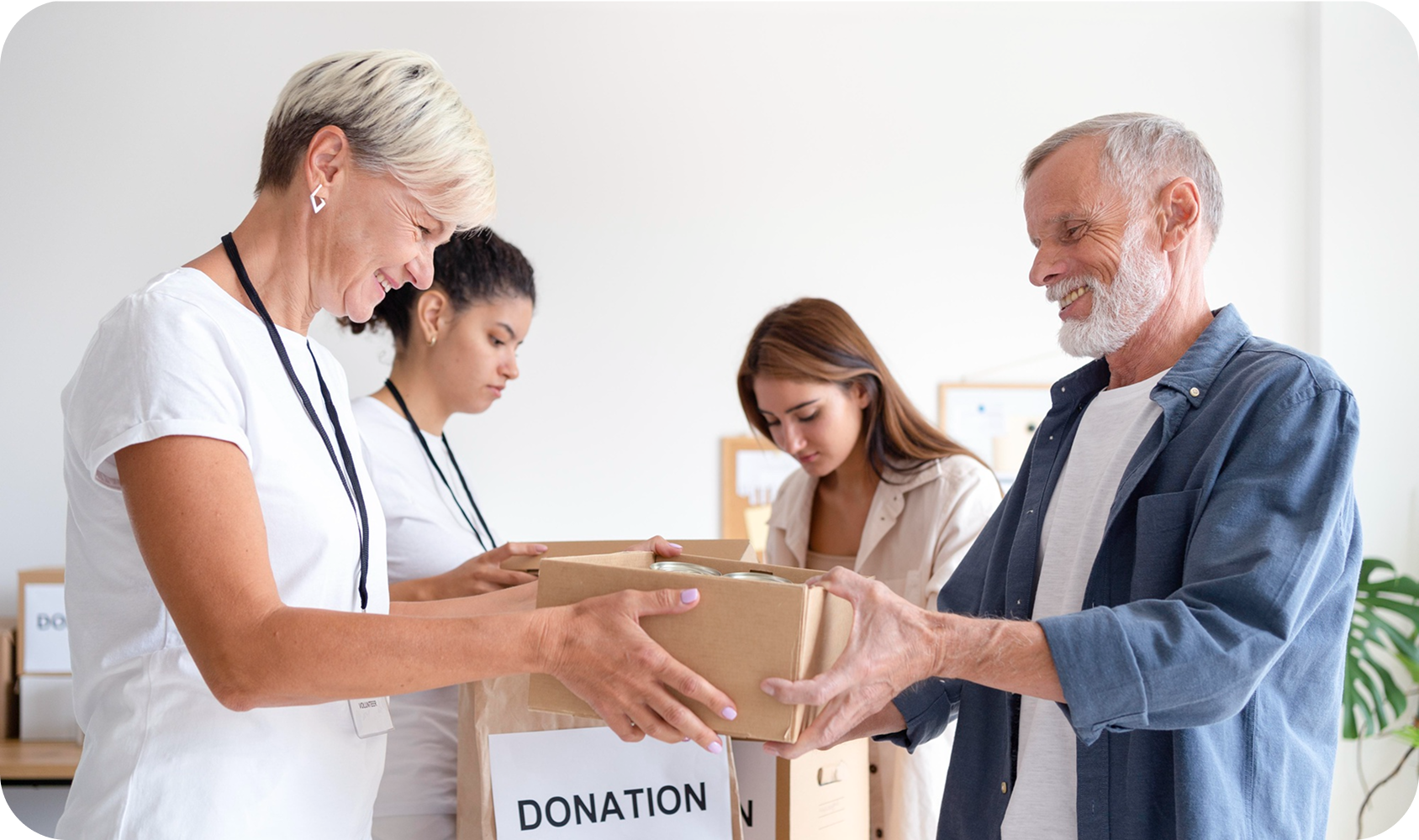 Volunteers handing a donation box to a grateful man