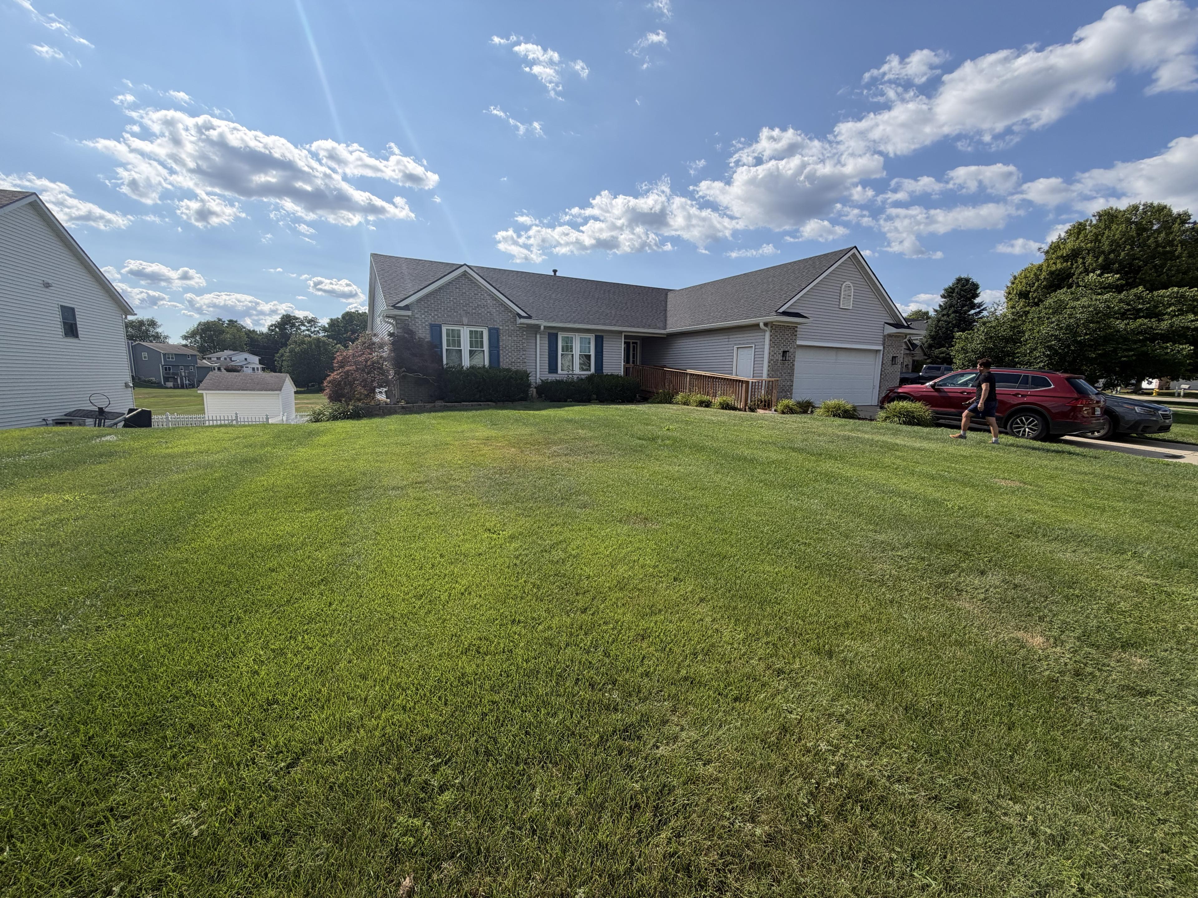 Neighborhood view of the home from across its front lawn