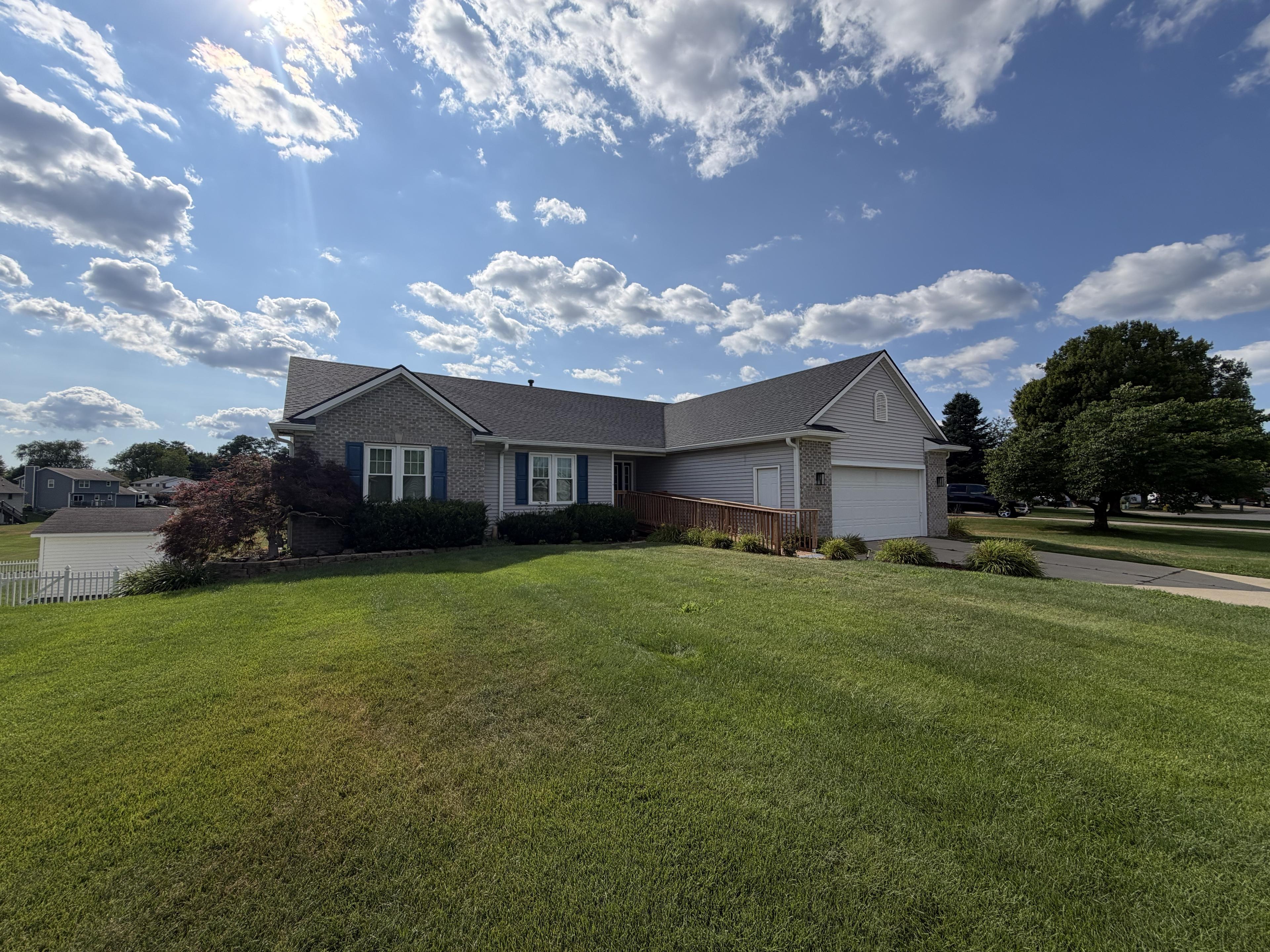 Side view of the home showing the ramped entry and open green space