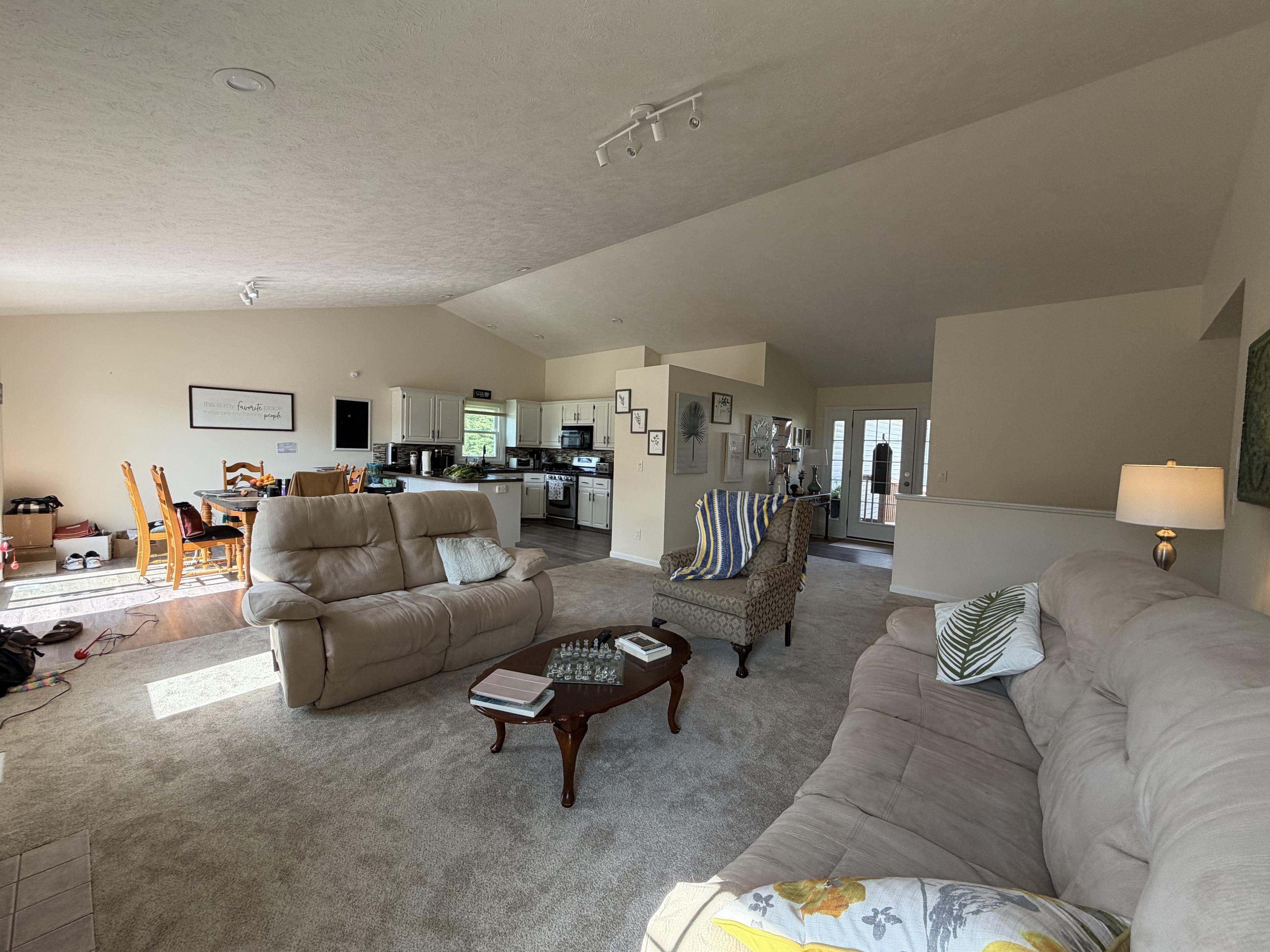 Open-concept great room connecting the lounge, dining table, and kitchen