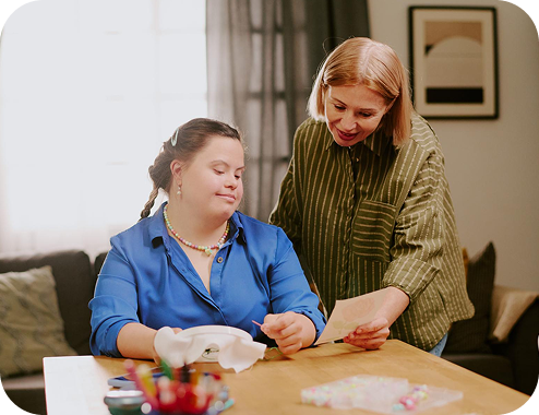 A caregiver embracing a smiling resident