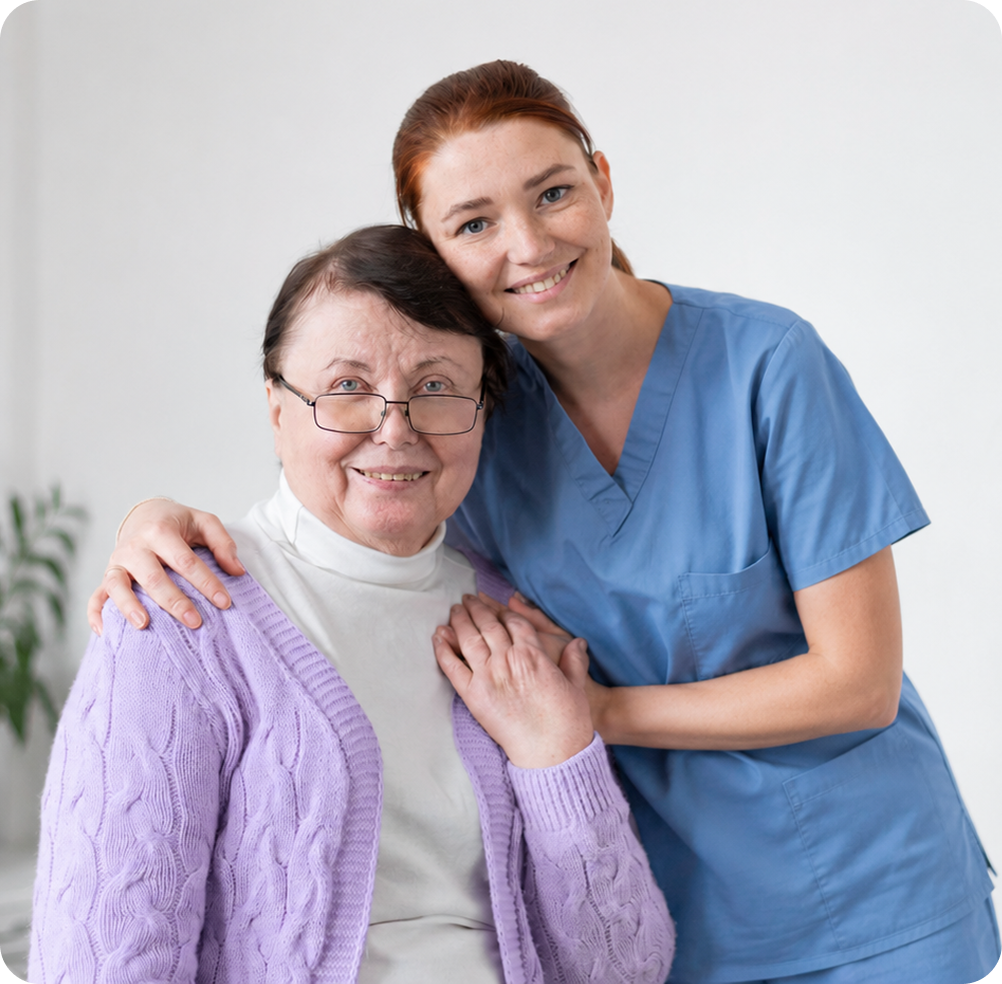 A caregiver and a smiling resident sharing a warm embrace